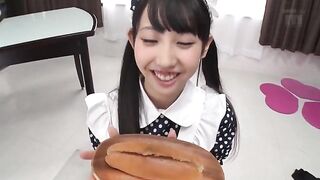 Cute Asian eats a hotdog