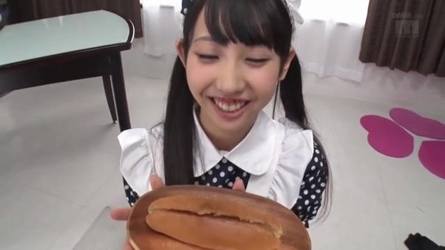 Cute Asian eats a hotdog